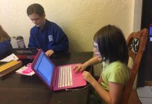 two kids working on computers