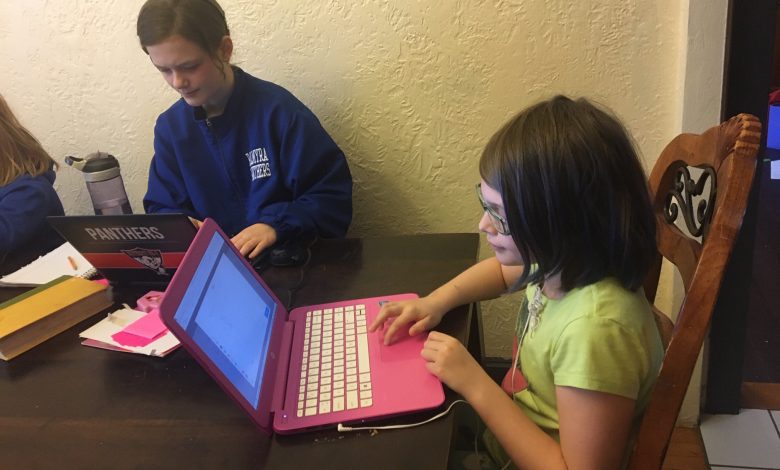 two kids working on computers